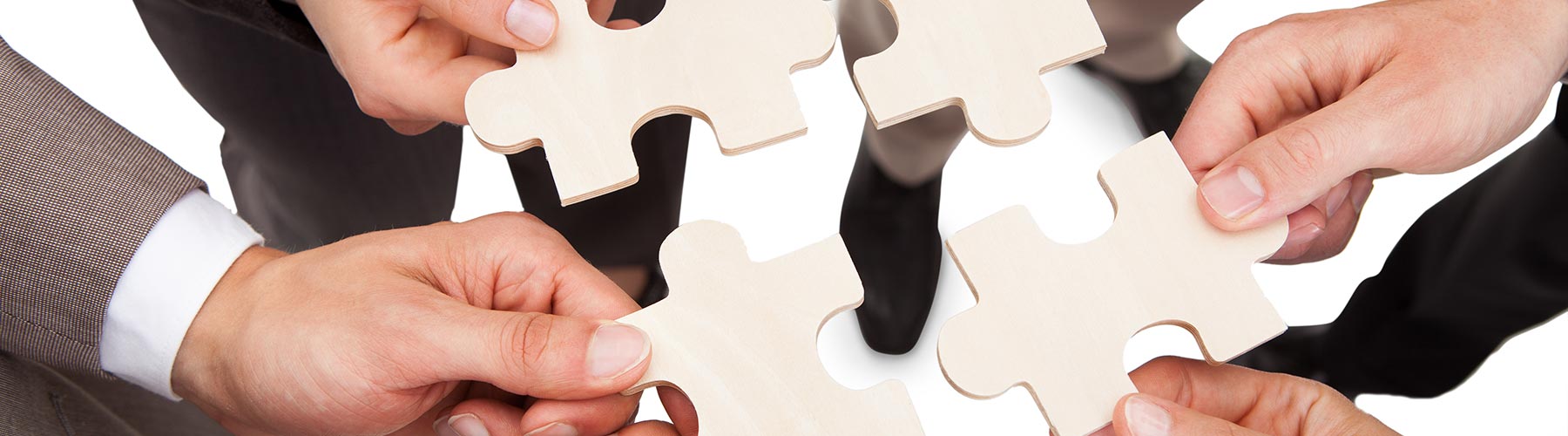 business people holding puzzle pieces together
